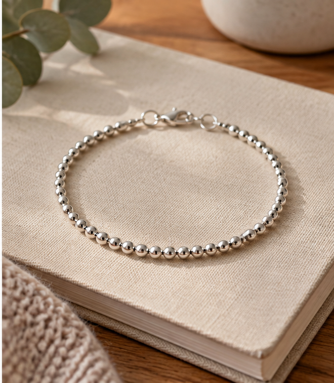 Silver-tone bead bracelet catching fine daylight